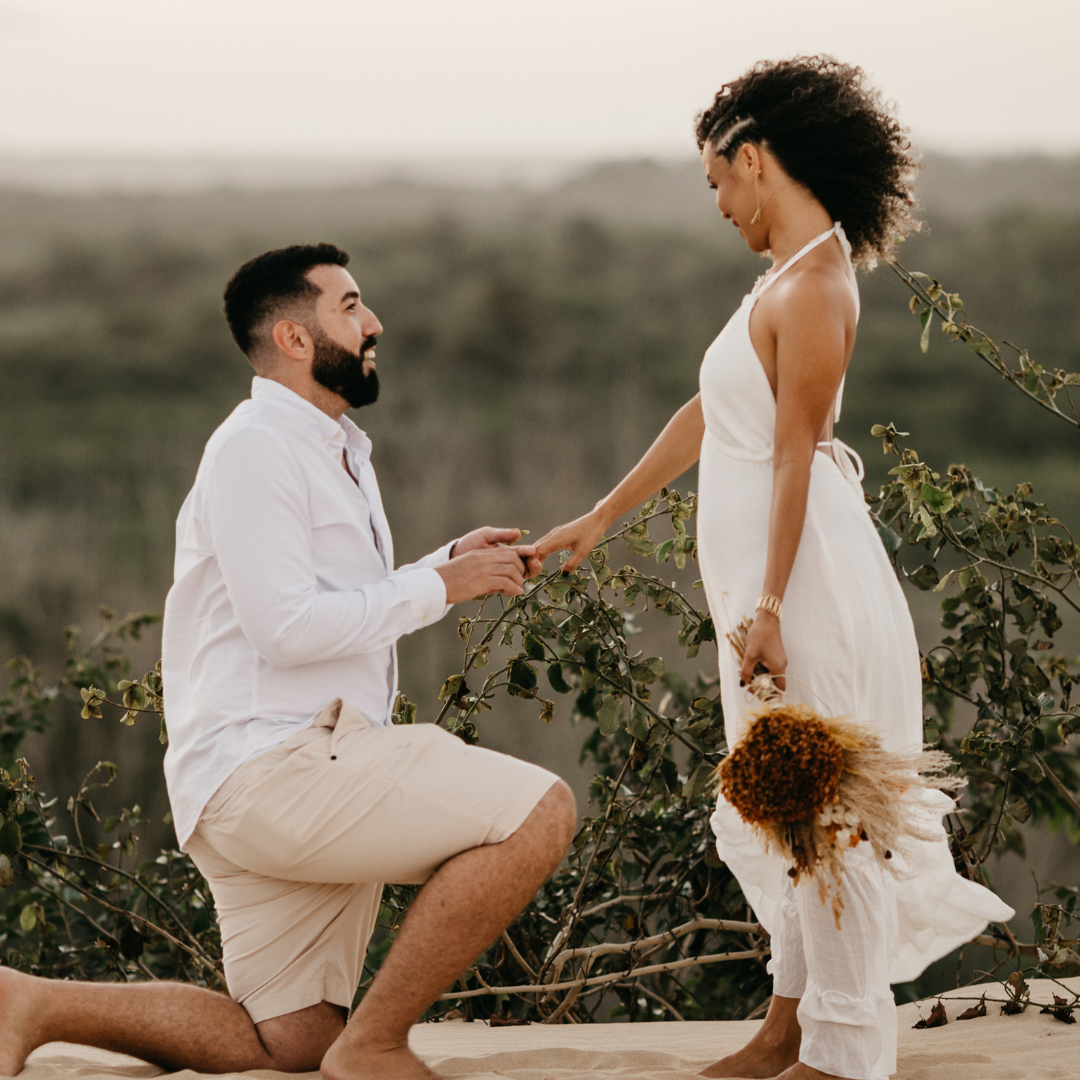Man proposing to a woman on a scenic outdoor location
